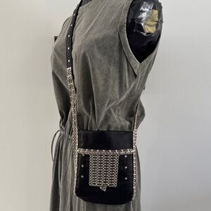 Black leather crossbody/shoulder bag with silver accents .